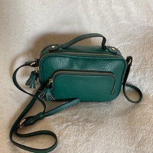 Nii G crossbody bag. Cute green bag with black and white interior lining.
